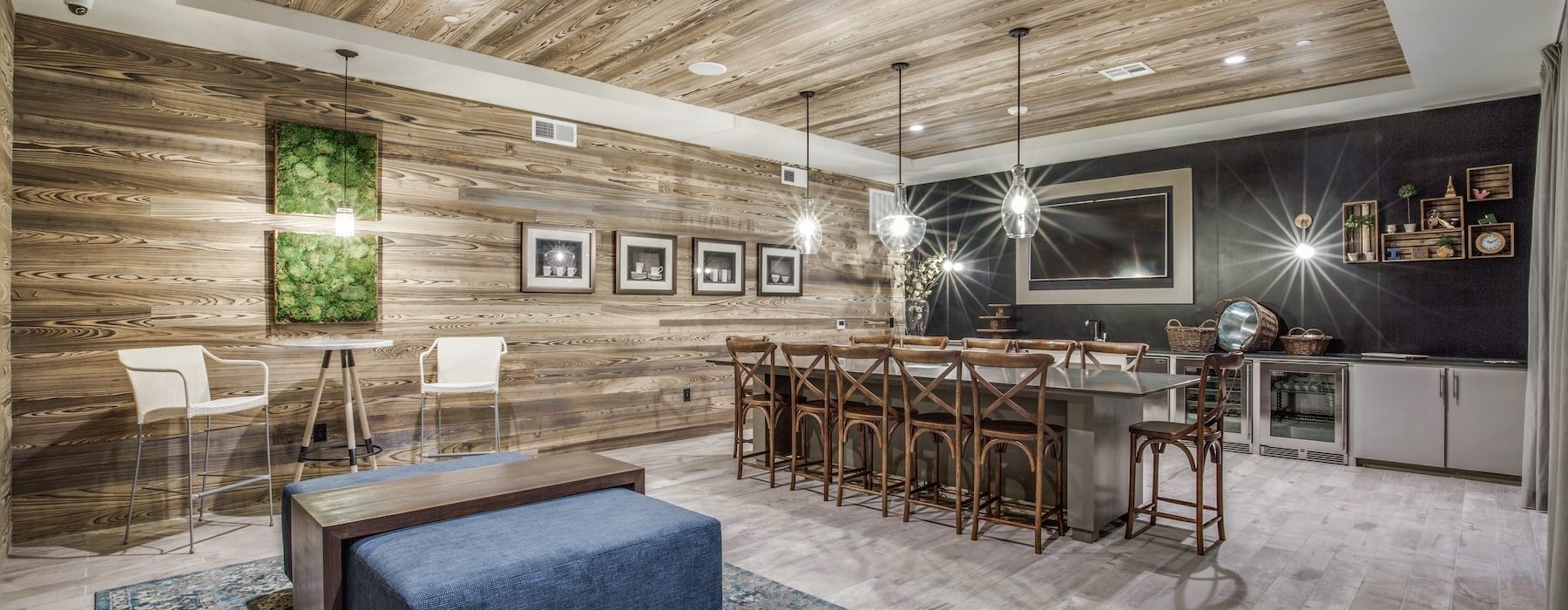 a clubroom kitchen with an island and chairs