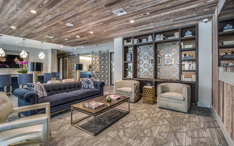 a clubroom with a couch, a table and chairs