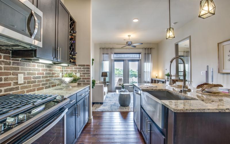 a kitchen with a brick backsplash