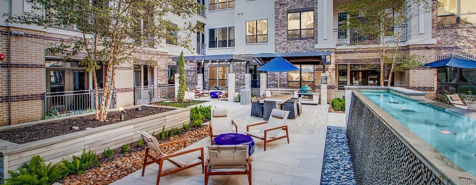 a courtyard with chairs and a water fountain